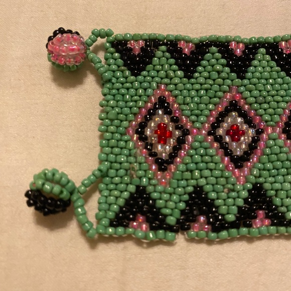 Handmade Huichol-style seed bead bracelet featuring green, black, pink & red. - Picture 2 of 6